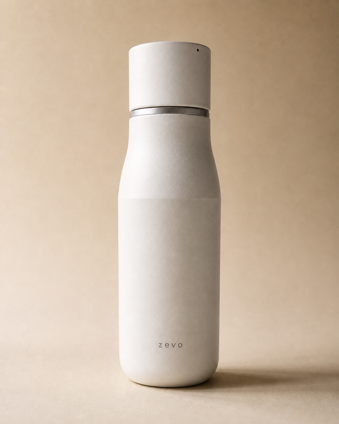 Zevo Smart Hydration Bottle in matte stone finish on warm sand backdrop